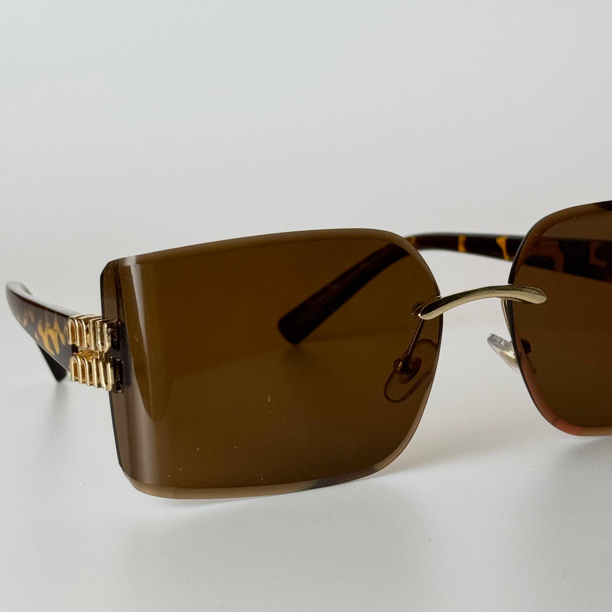 Miu Miu Rimless Rectangle – Black Gold