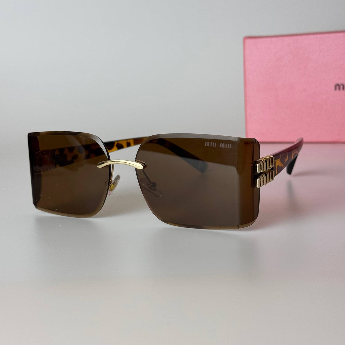 Miu Miu Rimless Rectangle – Black Gold