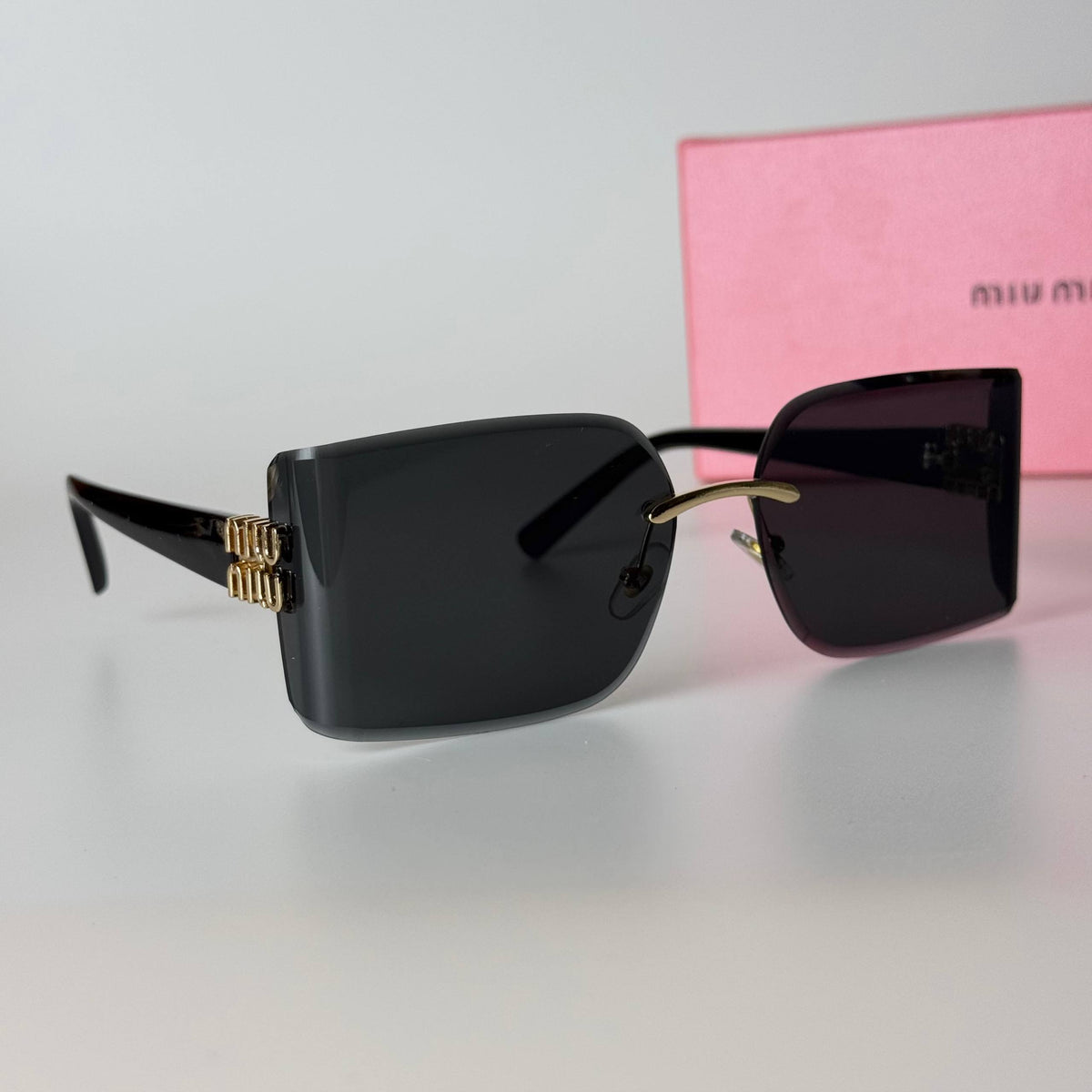 Miu Miu Rimless Rectangle – Black Gold