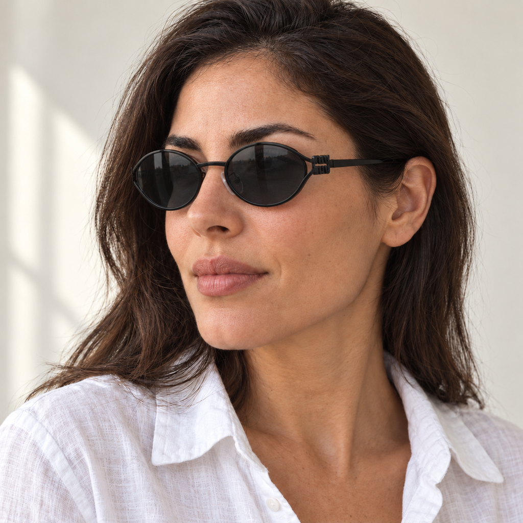AI-generated styling image: model wearing Miu Miu Oval SMU54Z – Black Grey sunglasses. Fit and scale are illustrative. October 2026 refresh.
