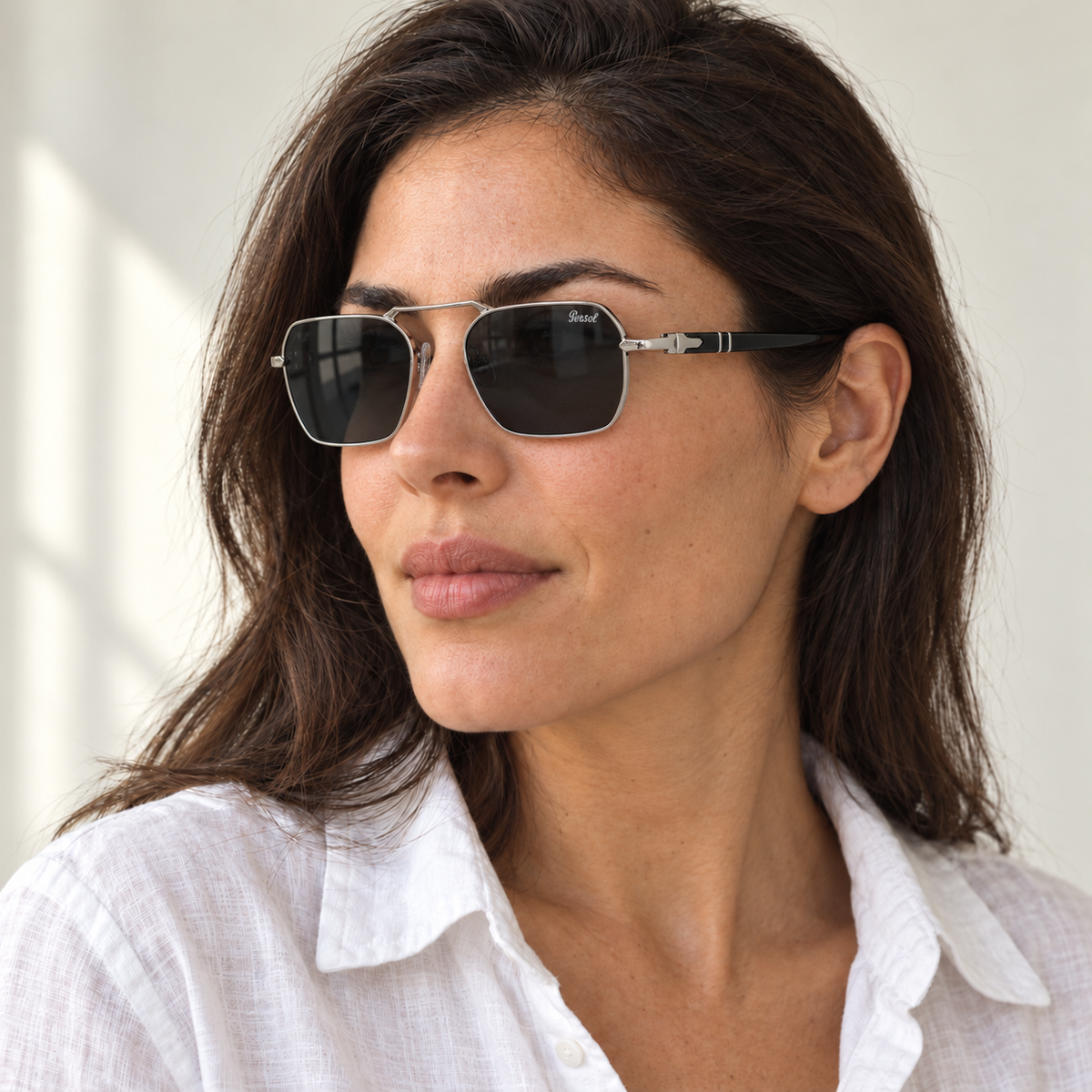 AI-generated styling image: model wearing Persol PO3321S – Silver Black sunglasses. Fit and scale are illustrative. October 2026 refresh.