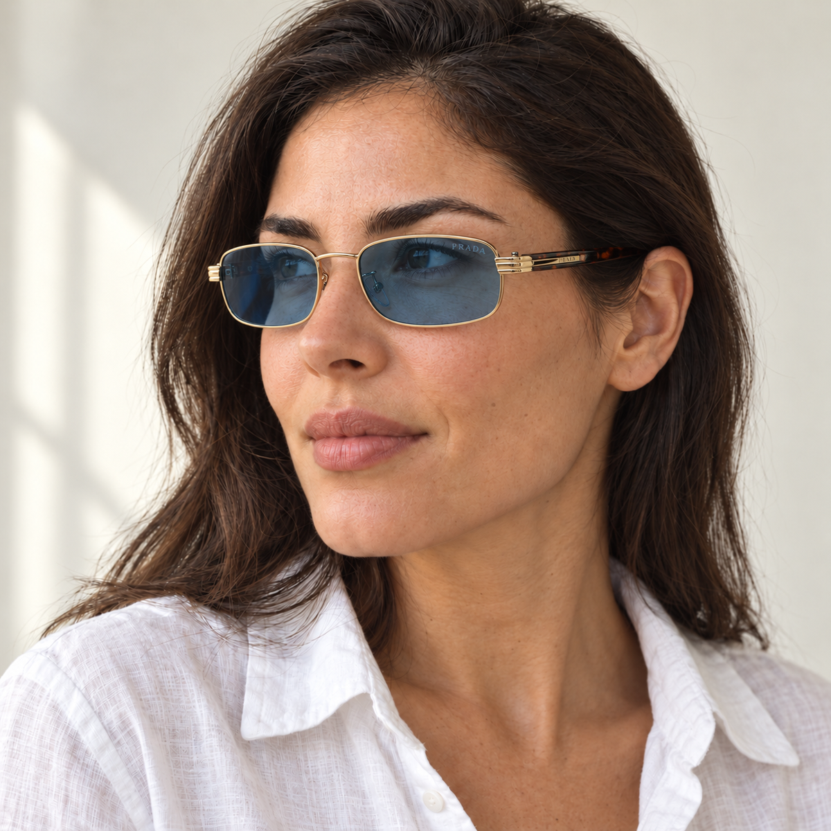 AI-generated styling image: model wearing Prada Rectangular PR6294 – Gold Blue sunglasses. Fit and scale are illustrative. October 2026 refresh.